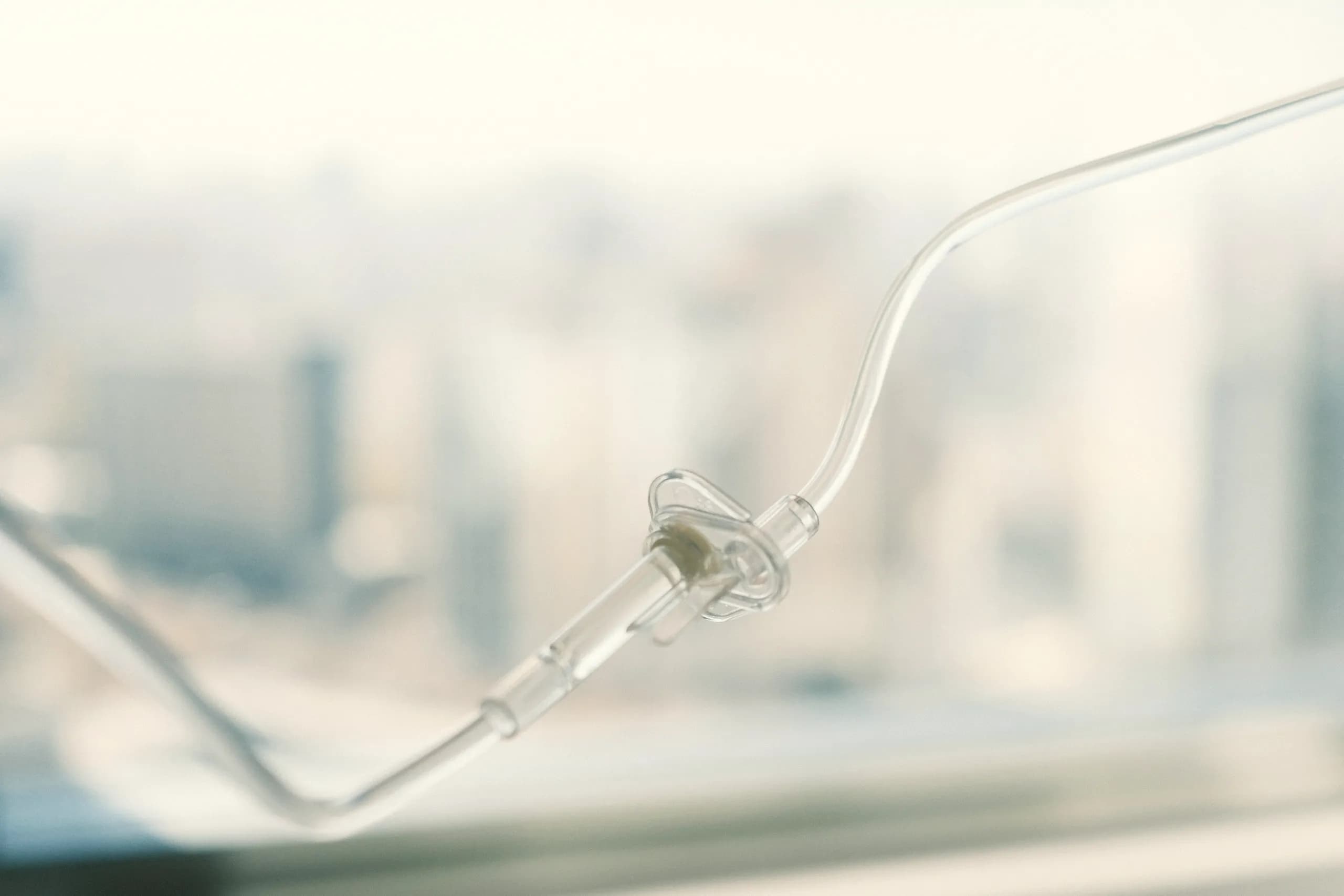 A close view of an IV infusion line in soft daylight.